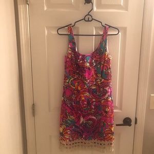 Lilly Pulitzer dress with gold fringe around the hem.